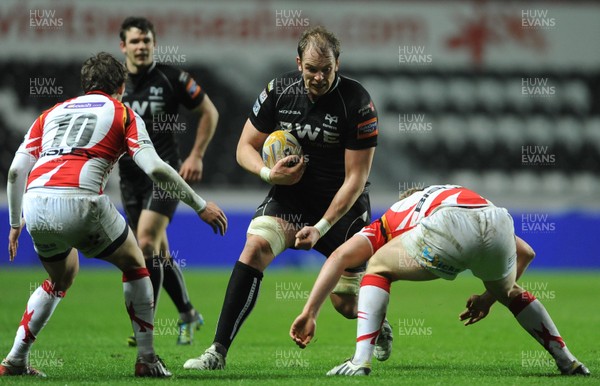 220313 -  Ospreys v Newport-Gwent Dragons - RaboDirect PRO12 -Alun Wyn Jones of Ospreys is tackled by Jack Dixon of Newport-Gwent Dragons 