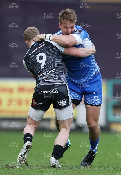 230319 - Ospreys v Dragons - Guinness PRO14 - Tyler Morgan of Dragons is tackled by Aled Davies of Ospreys
