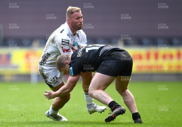 250323 - Ospreys v Dragons - United Rugby Championship - Ross Moriarty of Dragons is tackled by Keiran Williams of Ospreys