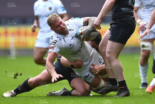 250323 - Ospreys v Dragons - United Rugby Championship - Ross Moriarty of Dragons is tackled by Tom Botha of Ospreys