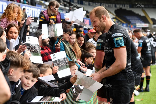 250323 - Ospreys v Dragons - United Rugby Championship - Alun Wyn Jones of Ospreys signs autographs for supporters