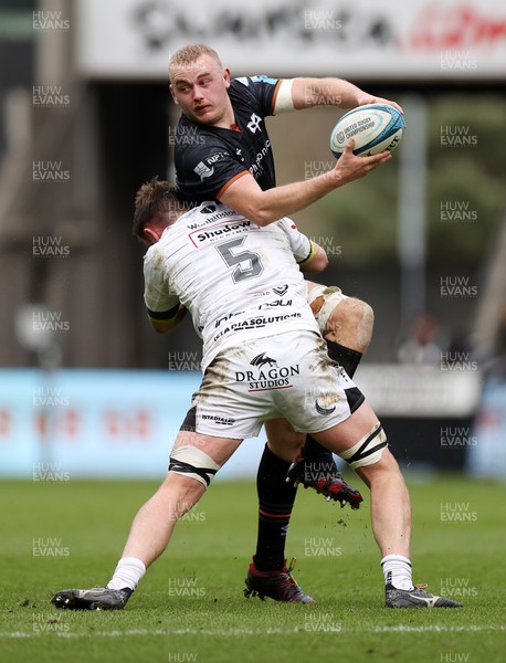 250323 - Ospreys v Dragons - United Rugby Championship - Huw Sutton of Ospreys is tackled by George Nott of Dragons 