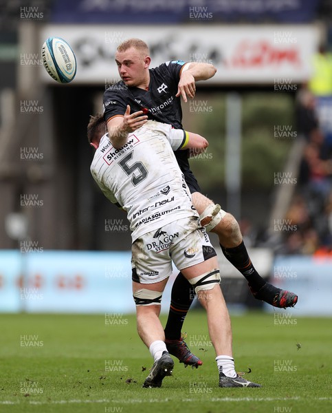 250323 - Ospreys v Dragons - United Rugby Championship - Huw Sutton of Ospreys is tackled by George Nott of Dragons 