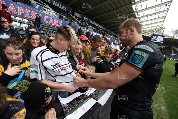 250323 - Ospreys v Dragons - United Rugby Championship - Alun Wyn Jones of Ospreys signs autographs