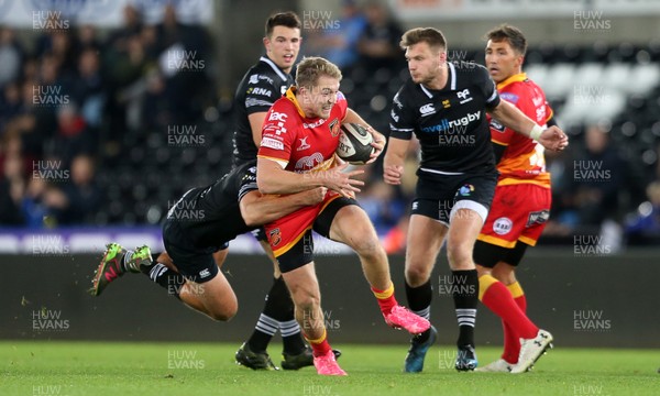 271017 - Ospreys v Dragons - Guinness PRO14 - Tyler Morgan of Dragons is tackled by Ashley Beck of Ospreys