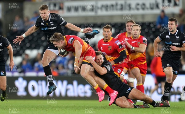 271017 - Ospreys v Dragons - Guinness PRO14 - Tyler Morgan of Dragons is tackled by Ashley Beck of Ospreys