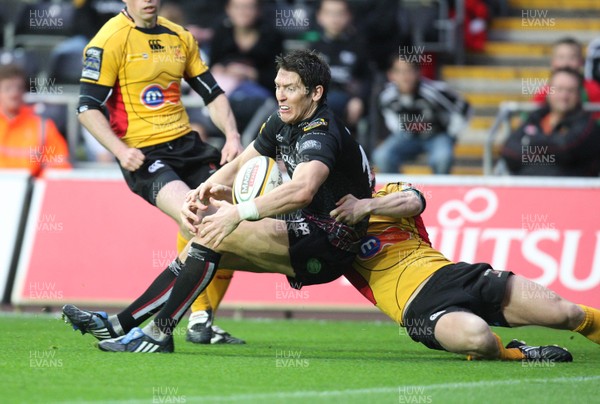 30.04.09 - Ospreys v Newport Gwent Dragons, Magners League -  Ospreys' James Hook is tackled by Dragons' Wayne Evans   