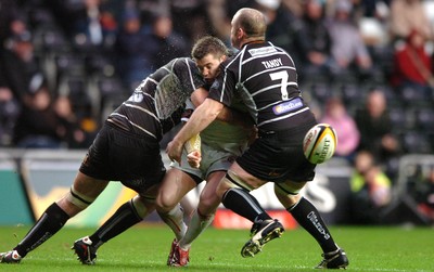 311206 - Ospreys v Newport Gwent Dragons - Magners League - Dragons Ceri Sweeney is tackled by Steve Tandy(R) and Andy Lloyd 