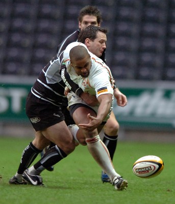 311206 - Ospreys v Newport Gwent Dragons - Magners League - Dragons Aled Brew is tackled by Shaun Conner 