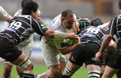 311206 - Ospreys v Newport Gwent Dragons - Magners League - Dragons Adam Black is tackled by Filo Tiatia 