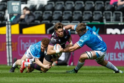 260425 - Ospreys v Dragons RFC - United Rugby Championship - Jack Walsh of Ospreys is tackled by Aneurin Owen of Dragons
