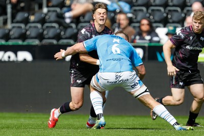 260425 - Ospreys v Dragons RFC - United Rugby Championship - Jack Walsh of Ospreys is tackled by Shane Lewis-Hughes of Dragons