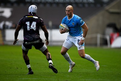 260425 - Ospreys v Dragons RFC - United Rugby Championship - Jared Rosser of Dragons is challenged by Dan Kasende of Ospreys