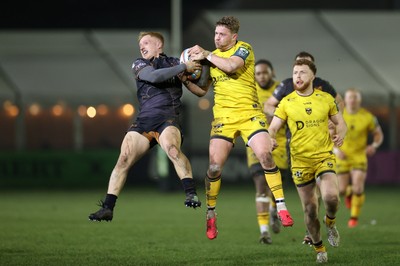 310126 - Ospreys v Dragons - United Rugby Championship - Iestyn Hopkins of Ospreys goes for the high ball with Angus O�Brien of Dragons 