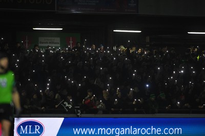 310126 - Ospreys v Dragons RFC - United Rugby Championship - Ospreys fans shine their phone lights in protest in the 11th minute