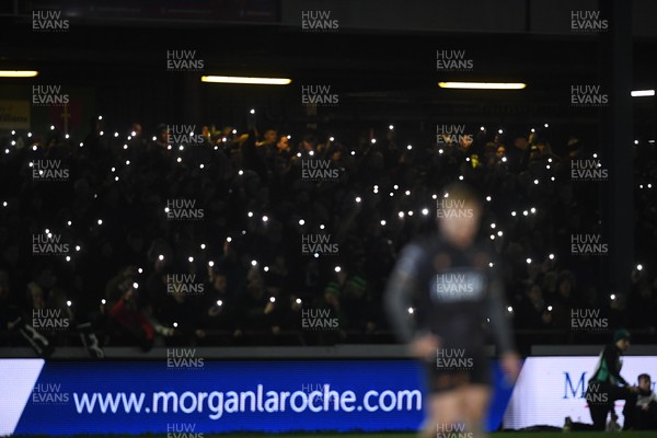 310126 - Ospreys v Dragons RFC - United Rugby Championship - Ospreys fans shine their phone lights in protest in the 11th minute