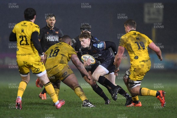 310126 - Ospreys v Dragons RFC - United Rugby Championship - Harri Houston of Ospreys is challenged by Cebo Dlamini of Dragons