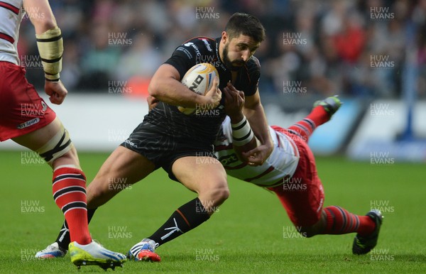 210913 - Ospreys v Edinburgh - RaboDirect PRO12 -Tito Tebaldi of Ospreys is tackled by Aleki Lutui of Edinburgh