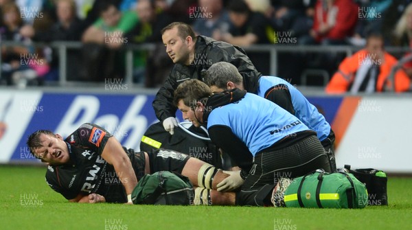 210913 - Ospreys v Edinburgh - RaboDirect PRO12 -Tom Smith of Ospreys is treated for an injury