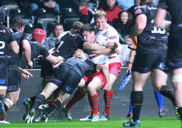 200913 Ospreys v Edinburgh - RaboDirectPro12 -Edinburgh's Harry Leonard is driven back in the tackle by Ospreys' Andrew Bishop(13) and Tom Grabham