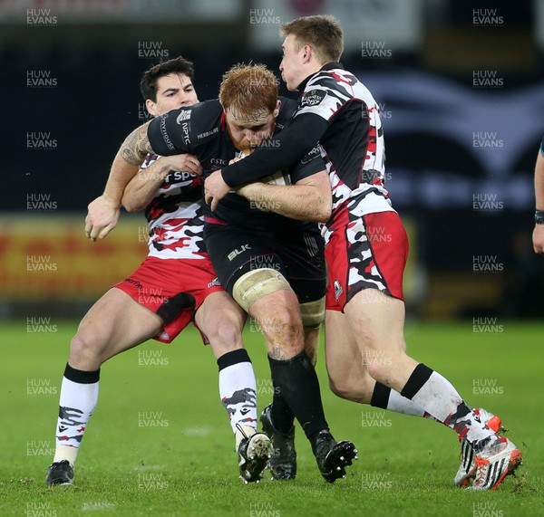 190216 - Ospreys v Edinburgh - Guinness PRO12 - Dan Baker of Ospreys is tackled by Sam Hidalgo-Clyne and Dougie Fife of Edinburgh