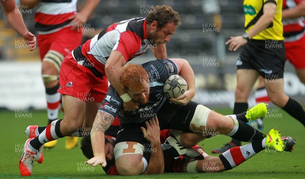 210914 - Ospreys v Edinburgh - Guinness PRO12 - Dan Baker of Ospreys is tackled by Fraser McKenzie and Andries Strauss of Edinburgh  