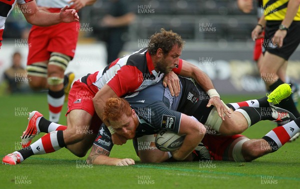 210914 - Ospreys v Edinburgh - Guinness PRO12 - Dan Baker of Ospreys is tackled by Fraser McKenzie and Andries Strauss of Edinburgh  