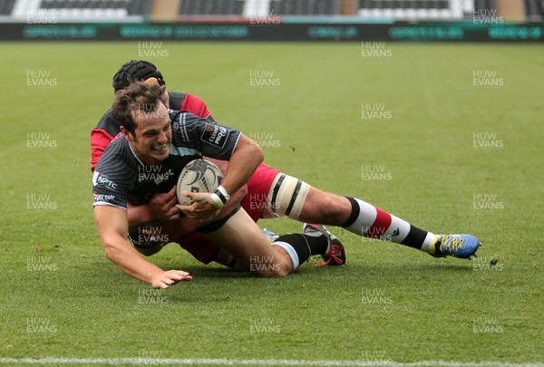 210914 - Ospreys v Edinburgh - Guinness PRO12 - Dan Evans of Ospreys is tackled just before the line by Fraser McKenzie of Edinburgh  