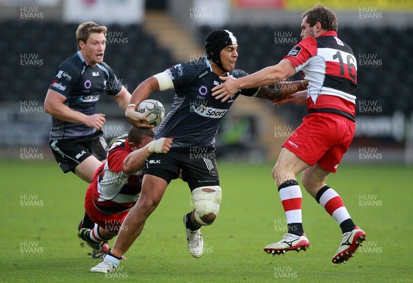 210914 - Ospreys v Edinburgh - Guinness PRO12 - Josh Matavesi of Ospreys is tackled by John Andress and Neil Cochrane of Edinburgh 