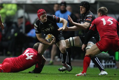 220213 - Ospreys v Edinburgh Rugby, RaboDirect PRO12 - Ospreys Richard Fussell is tackled by Edinburgh's Dougie Fife