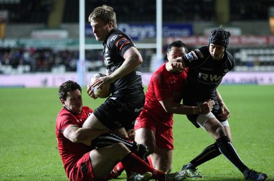 220213 - Ospreys v Edinburgh Rugby, RaboDirect PRO12 - Ospreys Jonathan Spratt  is tackled by Edinburgh's Nick De Luca