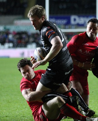 220213 - Ospreys v Edinburgh Rugby, RaboDirect PRO12 - Ospreys Jonathan Spratt  is tackled by Edinburgh's Nick De Luca