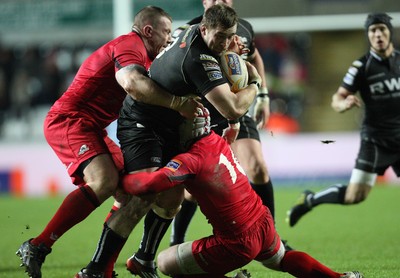 220213 - Ospreys v Edinburgh Rugby, RaboDirect PRO12 - Ospreys Morgan Allen is tackled by Edinburgh's John Yapp and Edinburgh's Andy Titterrell