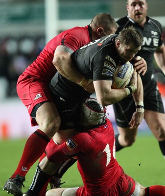 220213 - Ospreys v Edinburgh Rugby, RaboDirect PRO12 - Ospreys Morgan Allen is tackled by Edinburgh's John Yapp and Edinburgh's Andy Titterrell