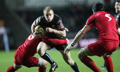 220213 - Ospreys v Edinburgh Rugby, RaboDirect PRO12 - Ospreys Tom Isaacs is tackled by Edinburgh's Stuart McInally and Edinburgh's Sean Cox