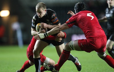 220213 - Ospreys v Edinburgh Rugby, RaboDirect PRO12 - Ospreys Tom Isaacs is tackled by Edinburgh's Stuart McInally and Edinburgh's Sean Cox