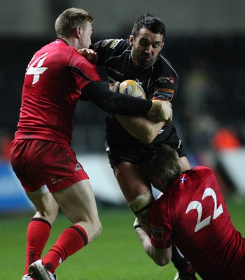 220213 - Ospreys v Edinburgh Rugby, RaboDirect PRO12 - Ospreys Jonathan Thomas is tackled by Edinburgh's Ben Cairns and Edinburgh's Dougie Fife 