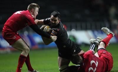 220213 - Ospreys v Edinburgh Rugby, RaboDirect PRO12 - Ospreys Jonathan Thomas is tackled by Edinburgh's Ben Cairns and Edinburgh's Dougie Fife 