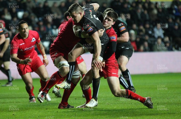 220213 - Ospreys v Edinburgh Rugby, RaboDirect PRO12 - Ospreys Rhys Webb is held by the Edinburgh defence