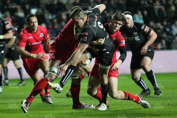 220213 - Ospreys v Edinburgh Rugby, RaboDirect PRO12 - Ospreys Rhys Webb is held by the Edinburgh defence