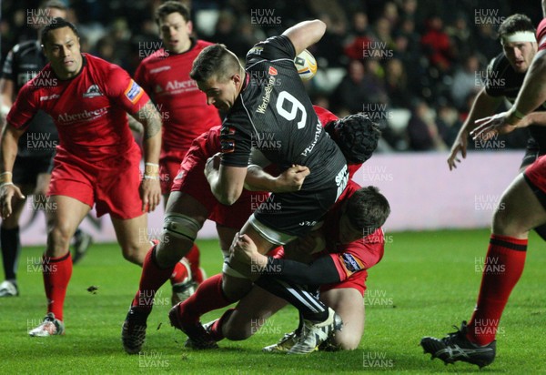 220213 - Ospreys v Edinburgh Rugby, RaboDirect PRO12 - Ospreys Rhys Webb is held by the Edinburgh defence