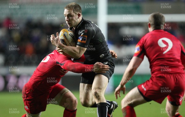 220213 - Ospreys v Edinburgh Rugby, RaboDirect PRO12 - Ospreys Tom Isaacs is tackled by Edinburgh's Andy Titterrell