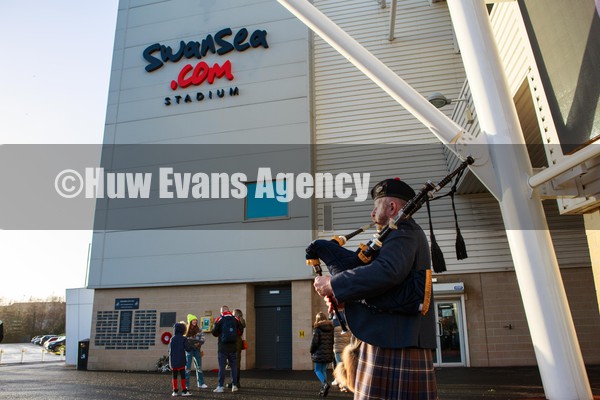 290122 - Ospreys v Edinburgh - United Rugby Championship - A piper plays the bagpipes outside the swanseacom Stadium before the match