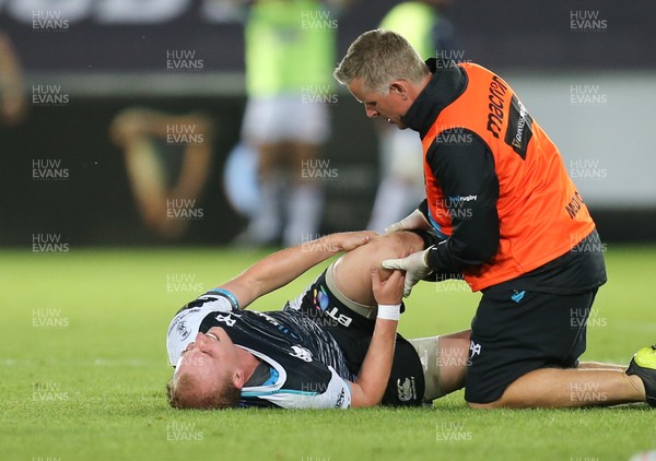 310818 - Ospreys v Edinburgh Rugby, Guinness PRO14 - Luke Price of Ospreys receives treatment after picking up an injury