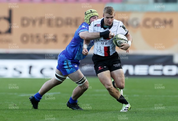 081224 - Ospreys v Emirates Lions, EPCR Challenge Cup - Nico Steyn of Lions is tackled by Harri Deaves of Ospreys 