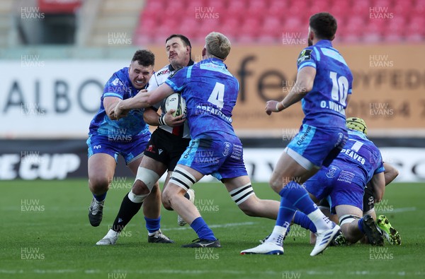 081224 - Ospreys v Emirates Lions, EPCR Challenge Cup - Morgan Naude of Lions is tackled by Ben Warren and Will Greatbanks of Ospreys 