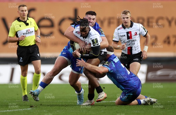 081224 - Ospreys v Emirates Lions, EPCR Challenge Cup - Rabz Maxwane of Lions is tackled by Gareth Thomas and Dewi Lake of Ospreys 