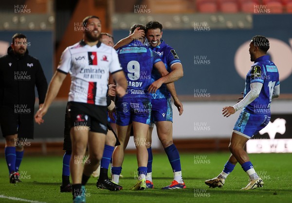 081224 - Ospreys v Emirates Lions, EPCR Challenge Cup - Kieran Hardy of Ospreys celebrates scoring a try with team mates