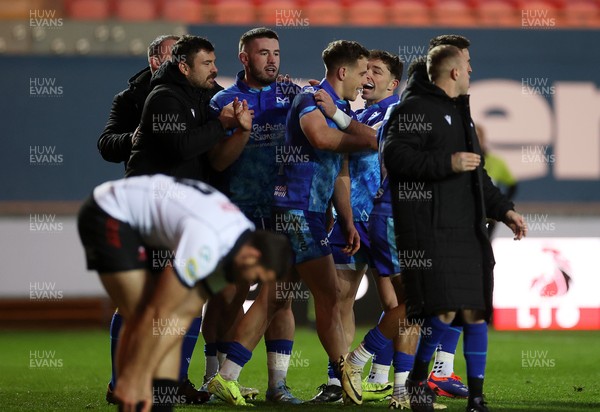 081224 - Ospreys v Emirates Lions, EPCR Challenge Cup - Kieran Hardy of Ospreys celebrates scoring a try with team mates