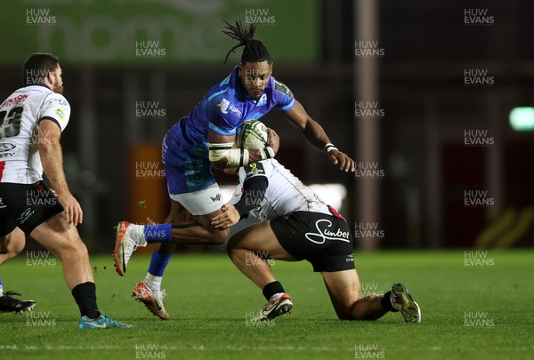 081224 - Ospreys v Emirates Lions, EPCR Challenge Cup - Dan Kasende of Ospreys is tackled by Rynhardt Jonker of Lions 